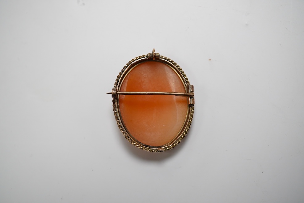 A yellow metal mounted oval cameo shell brooch, carved with The Three Graces, 30mm, gross weight 8 grams. Condition - fair